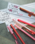 Colorful pens with personalized cards on a textured surface