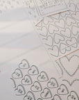 Sheet of heart-shaped stickers with 'I love you' text on a white background