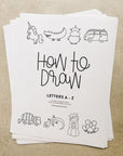 An image of the printed version of alphabet how to draw printables stacked showing the cover page which reads How to Draw