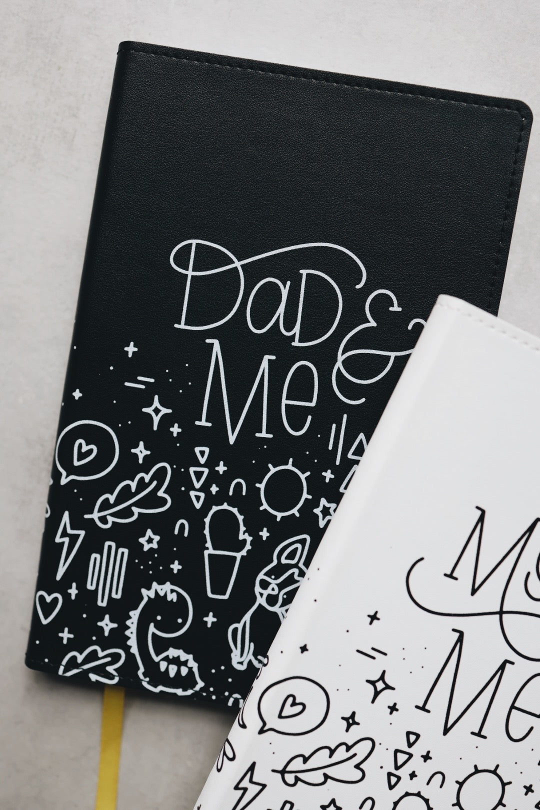 Dad & me journal partially obscured by mom & me journal