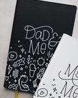 Dad & me journal partially obscured by mom & me journal
