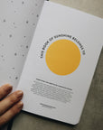 Friendship journal title page with three fingers holding it open