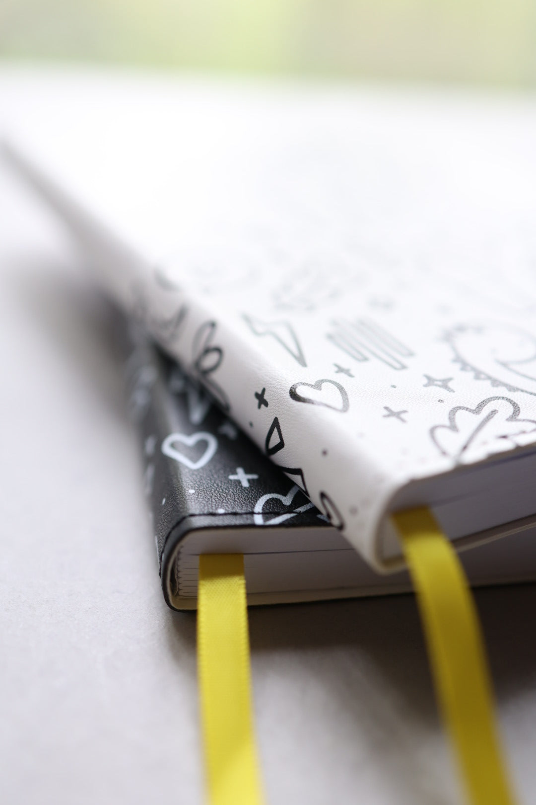 Artistic close up of journals stacked showing yellow bookmarks