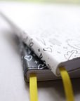 Artistic close up of journals stacked showing yellow bookmarks