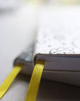Artistic shot of journals stacked showing yellow bookmarks