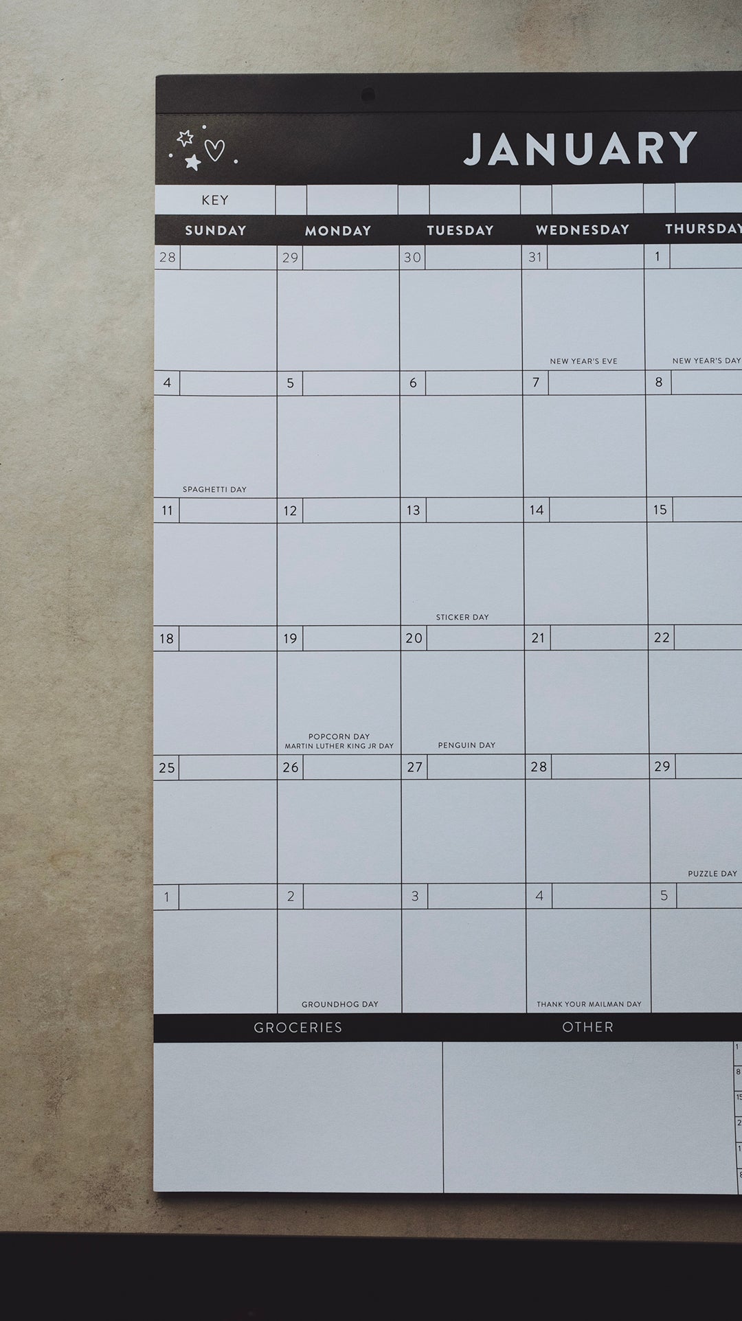 Left-hand side of a calendar for January laying on a light gray surface