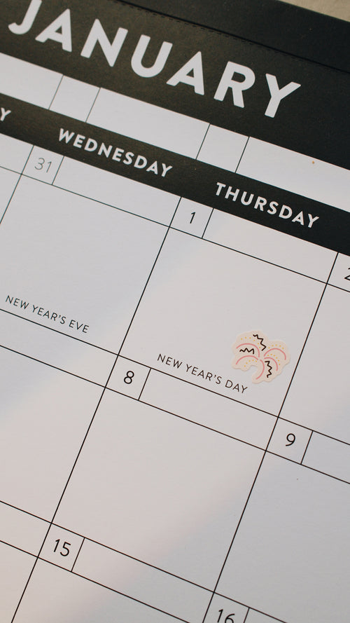 Calendar showing January with New Year's Day marked with a fireworks sticker