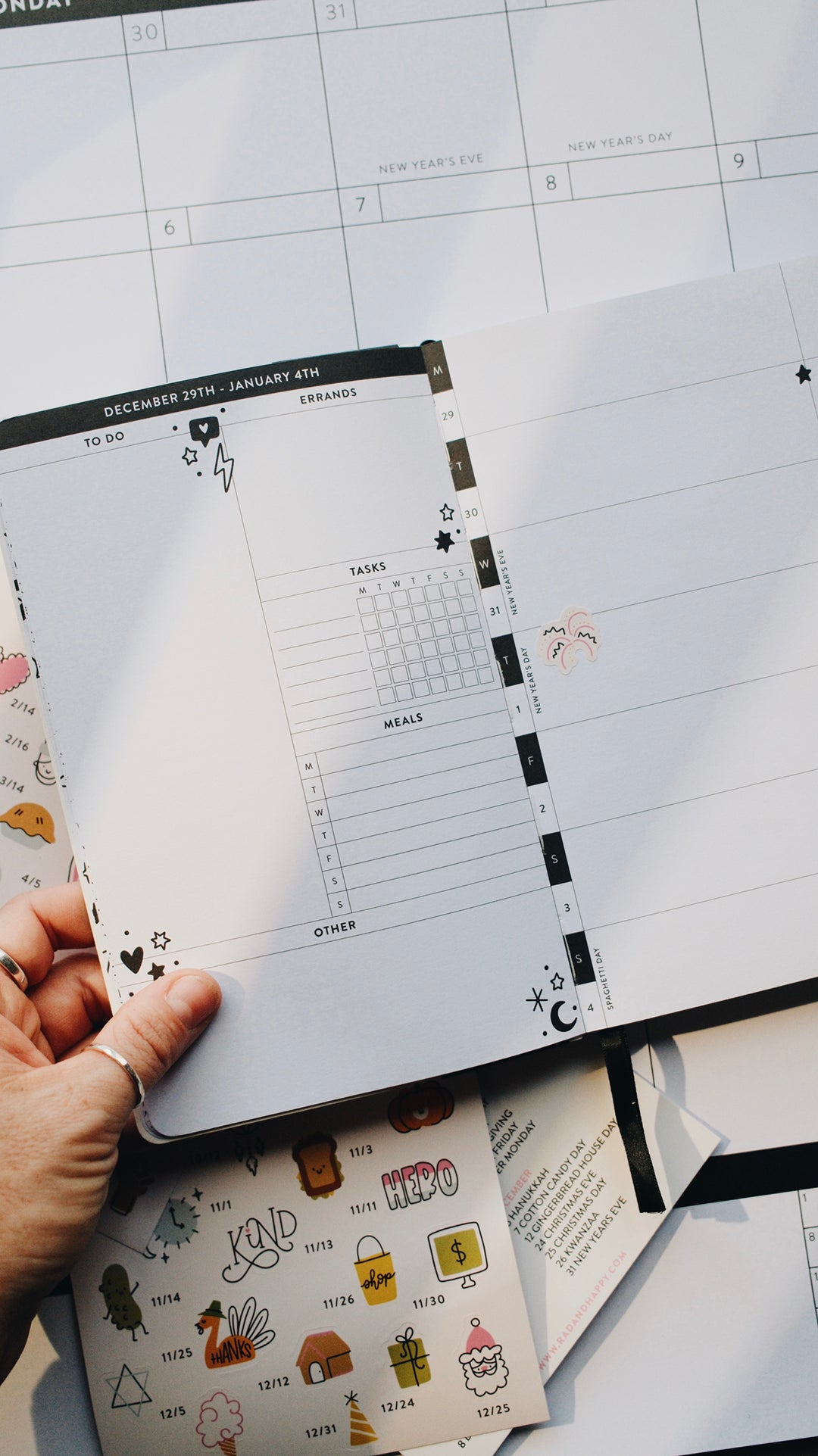 Planner with a fireworks sticker on a white surface