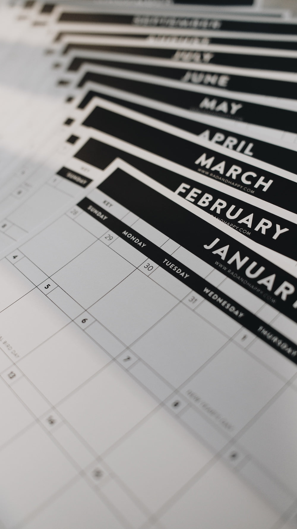 Calendar sheets with months printed on them, stacked and fanned out
