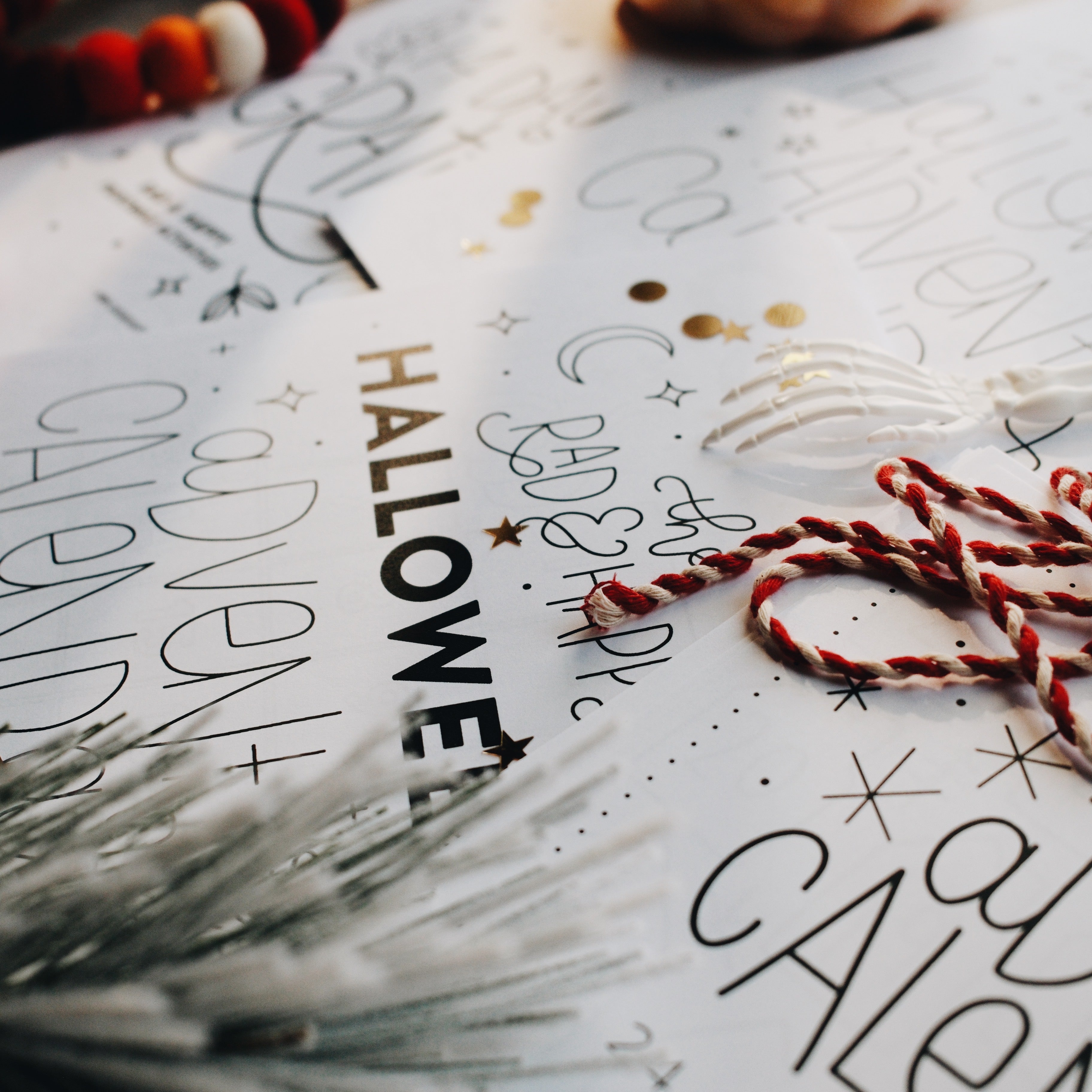 Side view of a Halloween advent calendar page with a red and white string on top