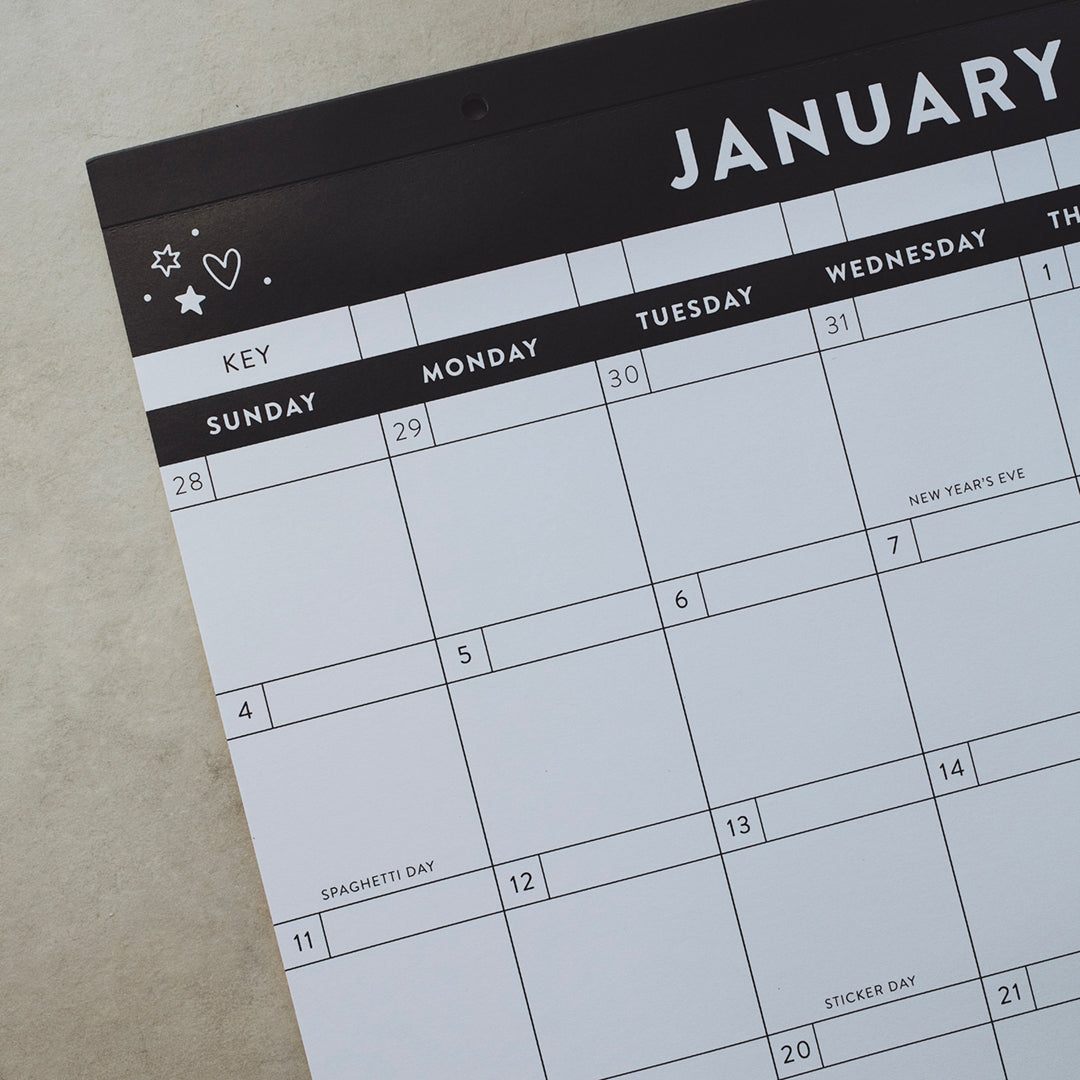 Left-hand corner of a calendar for January  with "New Year's Eve", "Spaghetti Day" and "Sticker Day" visible on various dates
