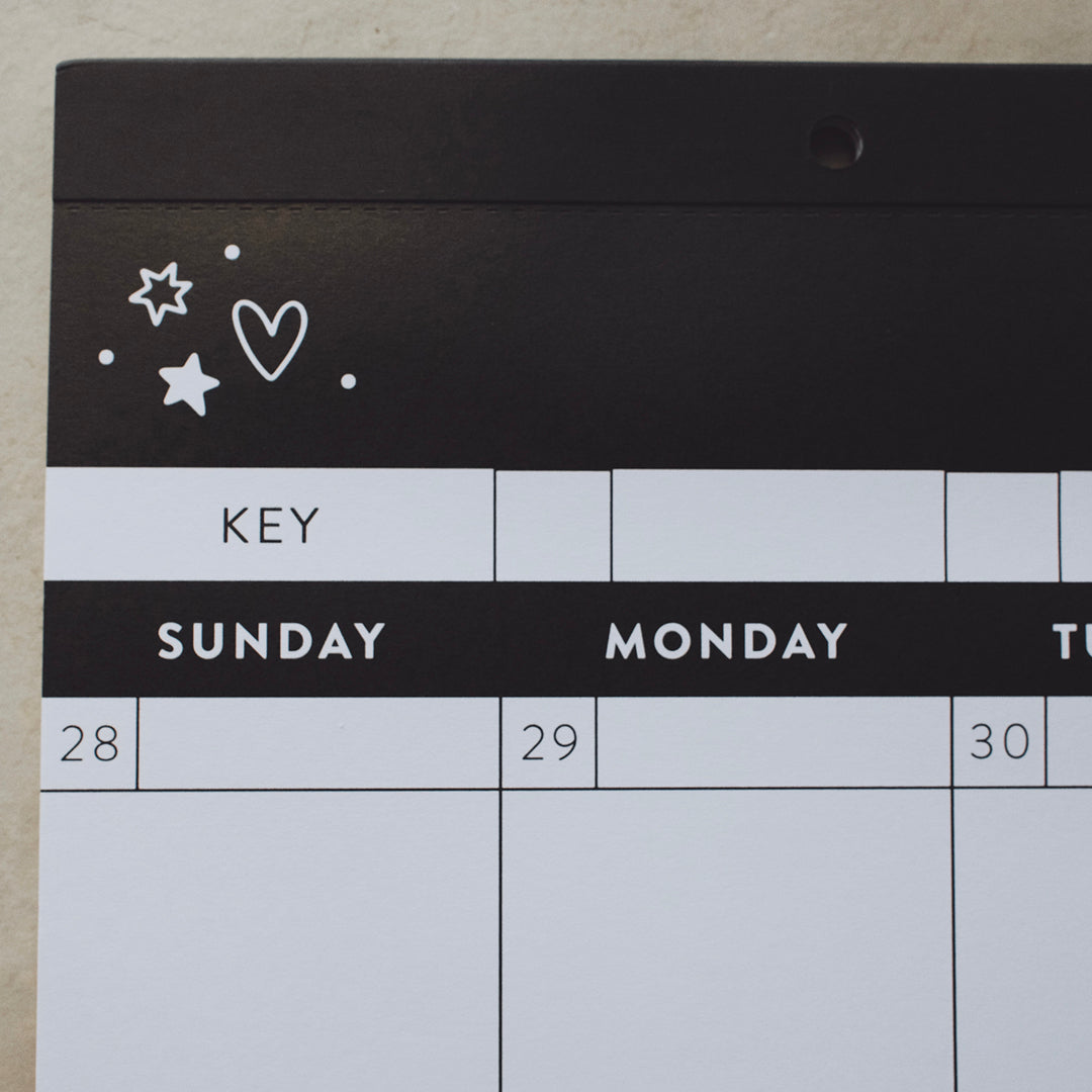 Left-hand corner of a calendar showing a doodle of a heart and stars above Sunday