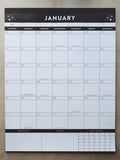 Black and white calendar on a light gray surface showing the month of January