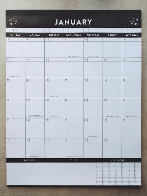 Black and white calendar on a light gray surface showing the month of January