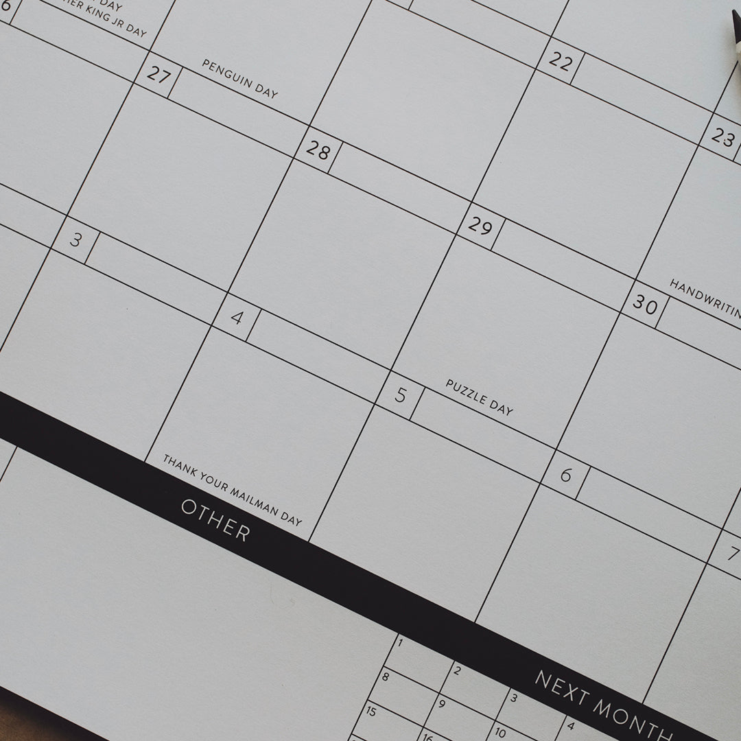 Close-up of a calendar showing "other" and "next month" on a black header