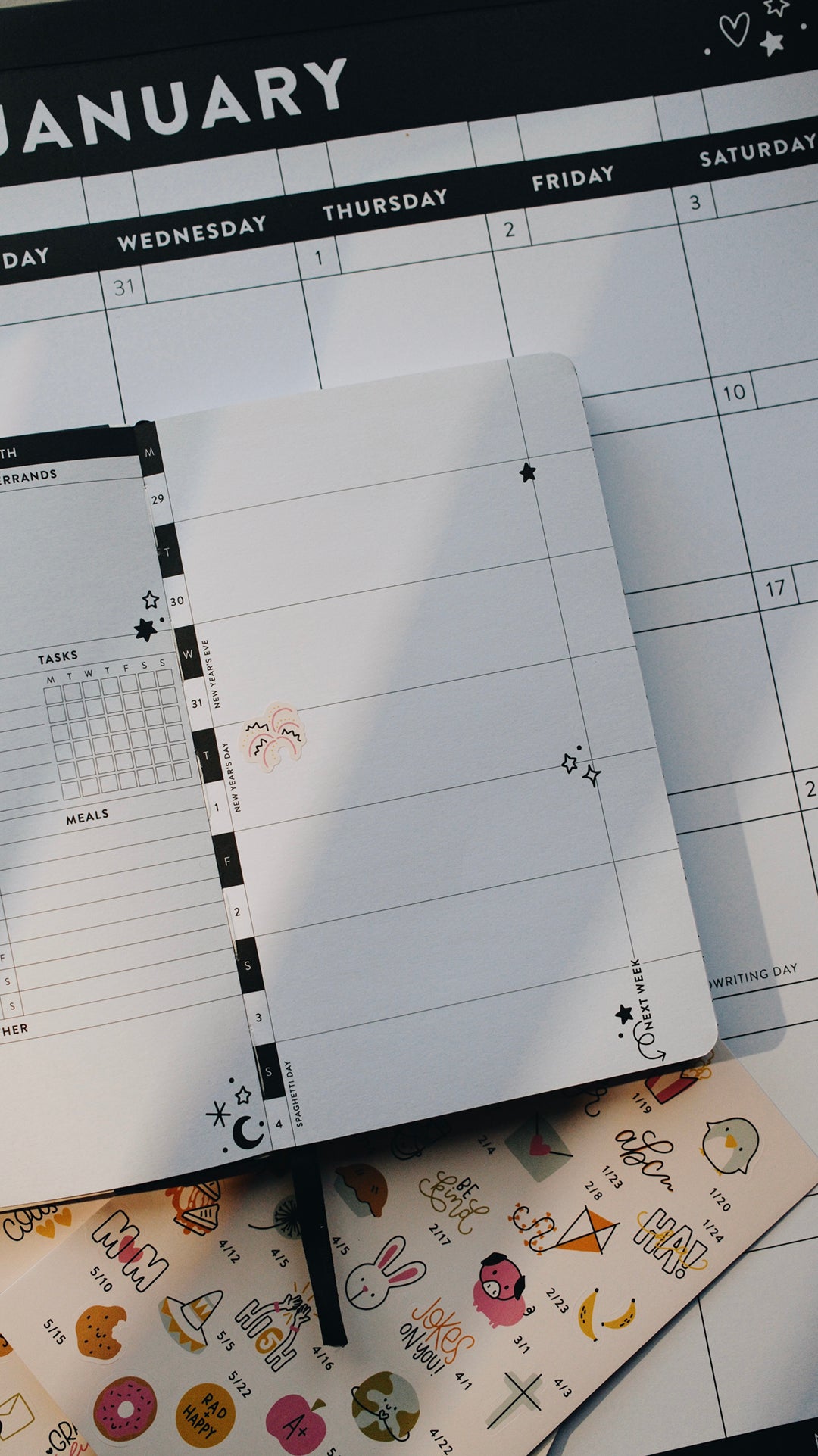 Planner with monthly layout and decorative sticker on a surface