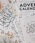 Advent calendar with Christmas-themed designs and decorative items on a white background