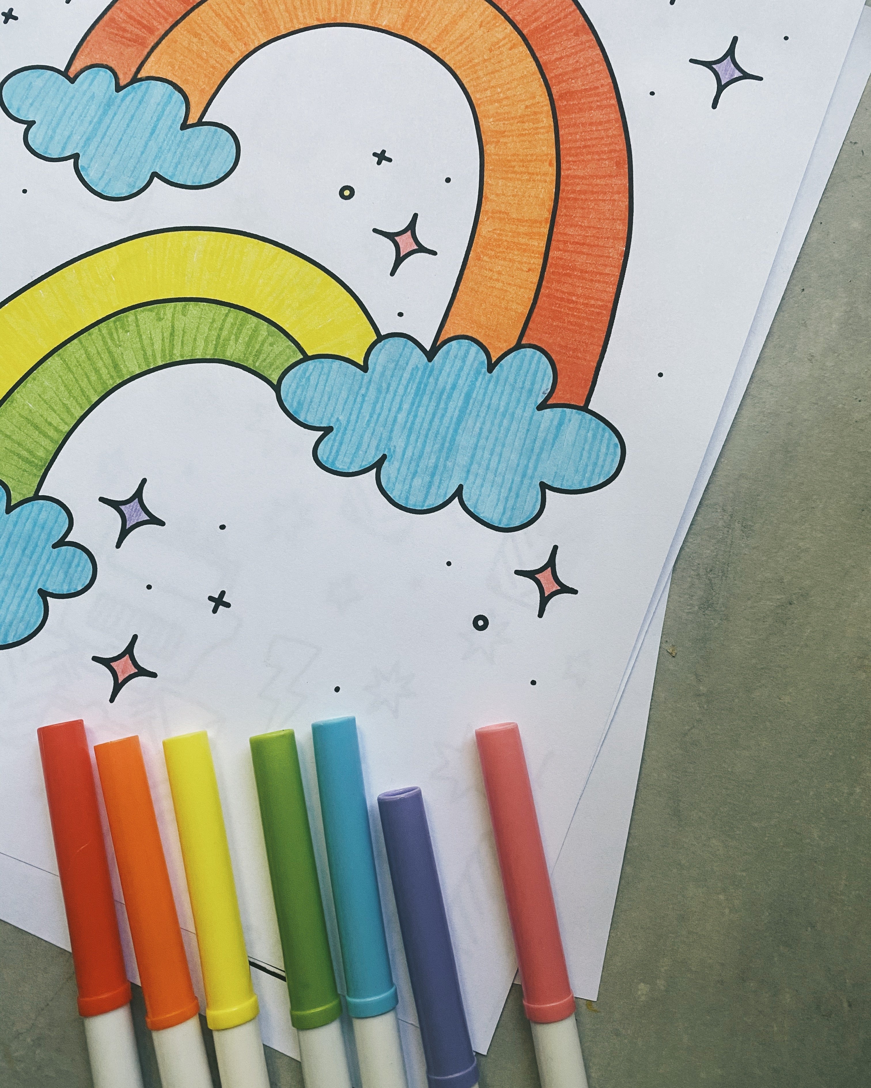 Colorful markers with a rainbow coloring page