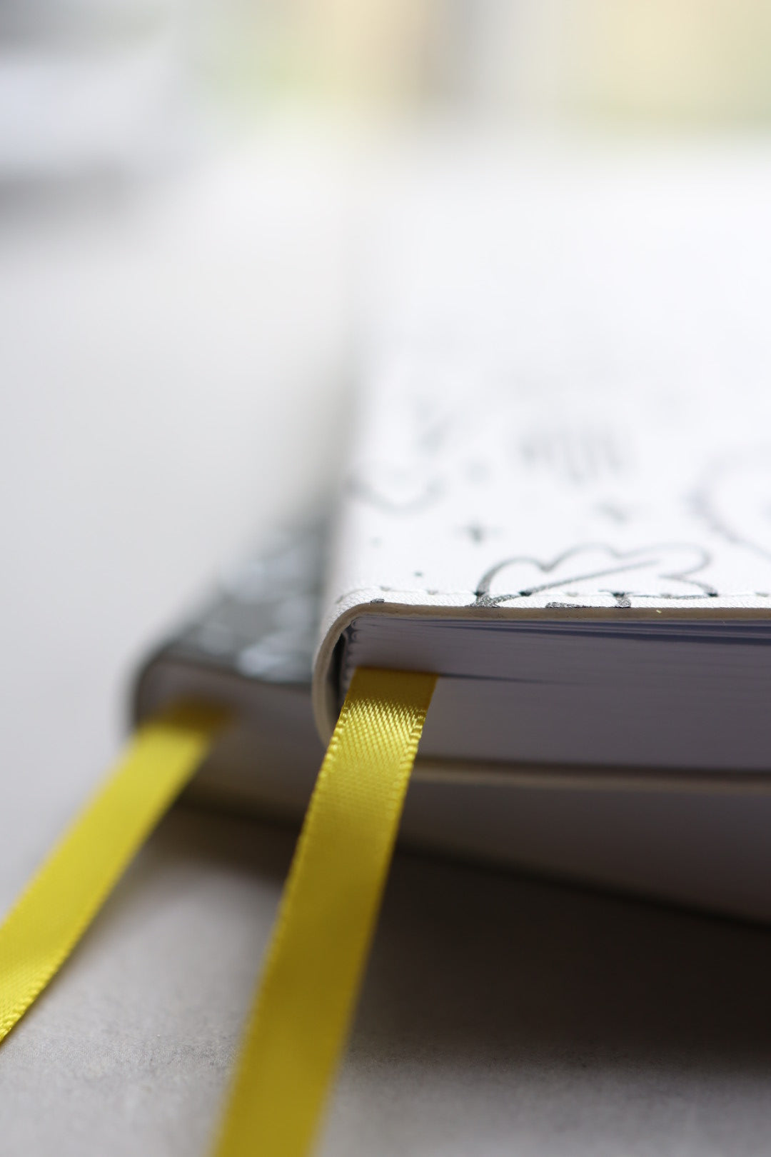 Artistic shot of journals stacked showing yellow bookmarks