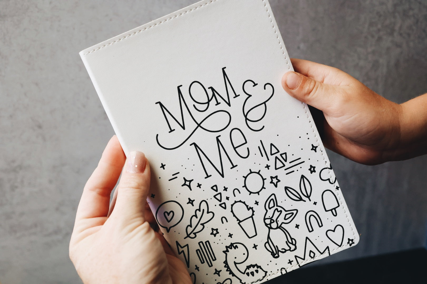 Close up of mom & me cover held by two hands