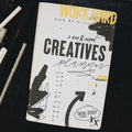 Creative planner sitting on desk along side pens and a ruler.